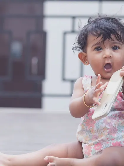 The best things in life come in small packages. This candid shot captures a baby's surprised and curious expression, a perfect memory of this fleeting stage.