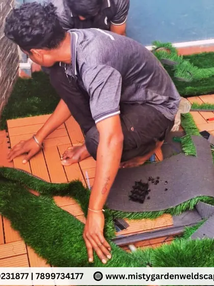 Our team custom cutting and fitting artificial grass around WPC tiles for a seamless and professional finish on a balcony floor.