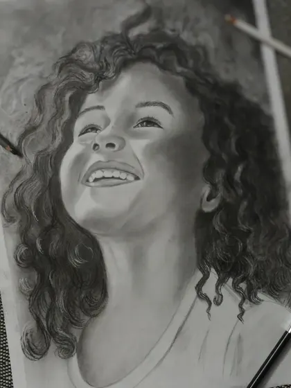 I created this charcoal portrait to capture the pure happiness in a child's expression. In my classes, I teach how to use light and shadow with charcoal to create this kind of depth and emotion, turning a simple sketch into a powerful piece of art.