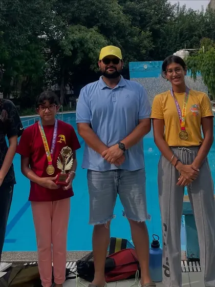My swimmers showcasing their 17-medal haul from India's biggest invitational swim meet. We also secured two 'Best Swimmer' trophies, proving our strength in a large, competitive field.
