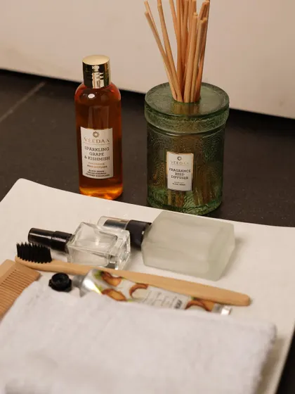 Our Sparkling Grape & Kishmish reed diffuser, placed on a tray with guest essentials. The sweet and fruity aroma gives any room a burst of fresh energy.