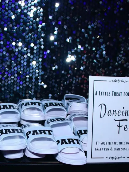 A little treat for tired dancing feet! We set up a station with comfortable slippers for guests to change into, ensuring they could stay on the dance floor all night long without a worry.