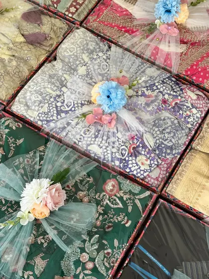 An overhead view of the baby shower gift trays, showing the variety of patterns and colors, all tied together with the same wrapping theme.