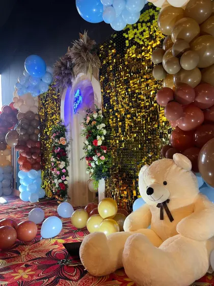 A large, cuddly teddy bear is a great prop for a teddy bear themed party, adding a soft and friendly element to the decor.