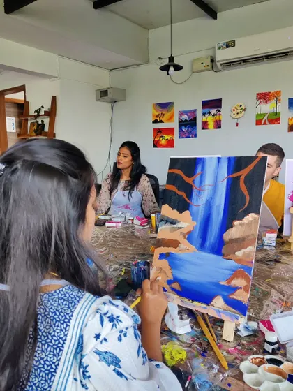 An instructor helping a participant with her waterfall painting. We’re always there to offer guidance and encouragement every step of the way.