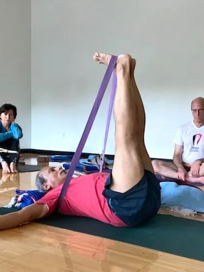 Guiding practitioners at the YMCA through a supine leg stretch. The principles of Iyengar yoga can be adapted to any setting.