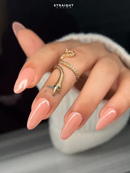 A close-up on the beautiful almond shape and the flawless application of this soft nude polish. It's a look of pure, simple elegance.