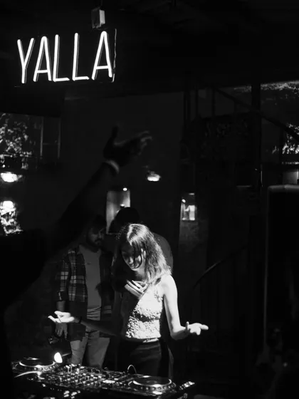 A black and white shot capturing the mood at Temple. The "YALLA" sign perfectly summed up the night's energy.