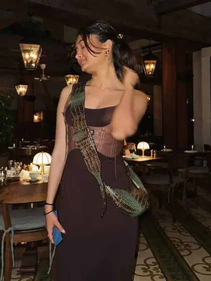 The Selena bag in a multi-toned croc print, styled for a dinner out. The unique colorway makes it a true statement piece.