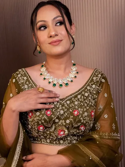 This olive green blouse with delicate red and pink floral embroidery is perfect for a mehendi look. We offer a variety of blouses that can be mixed and matched or rented as part of a set.