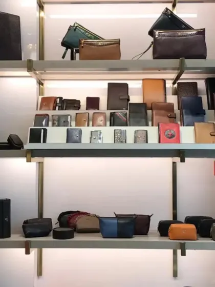 Shelving dedicated to wallets and small leather accessories, organized for easy browsing.