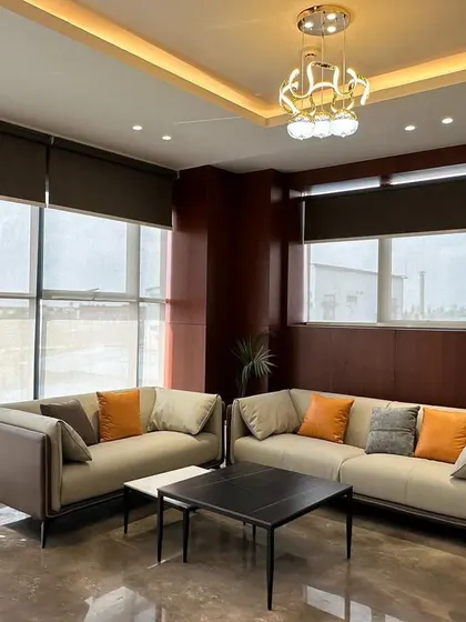The seating arrangement in the MD's waiting room, with two sofas facing each other over a minimalist black coffee table, encourages conversation.