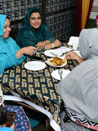 Ladies from the Bohra community sharing a meal and enjoying each other's company at Alamdar.