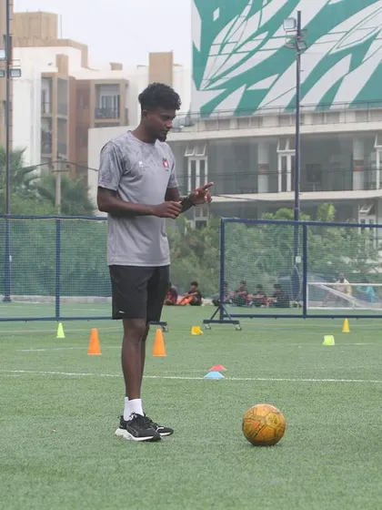 A coach uses his phone to demonstrate a technique or review a play during a Summer Camp session. We use modern tools to enhance our coaching.