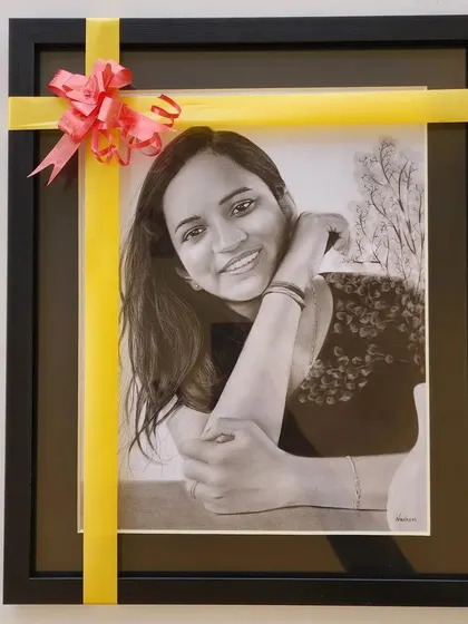 A beautifully wrapped and framed portrait, ready to be given as a thoughtful and personal gift.