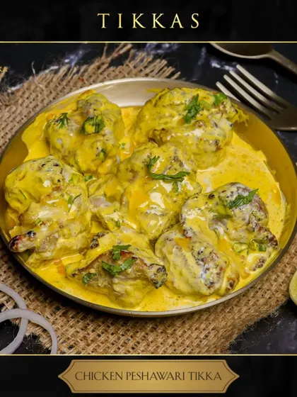 A close-up of my Chicken Peshawari Tikka, served in a traditional brass bowl. The creamy yellow sauce coats every piece of tender chicken, promising a burst of authentic flavour. This dish is a true feast for the senses.