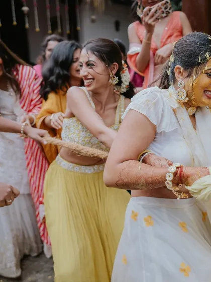 The bride and her team engage in a fun game of tug-of-war, a perfect example of how I incorporate playful activities into celebrations.