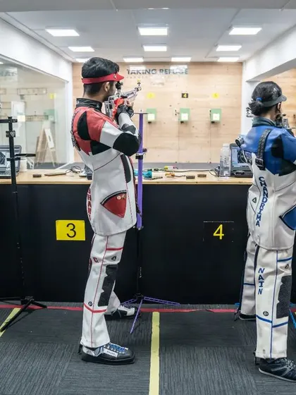 Shooters in formation during a practice session, each one focused on their target.