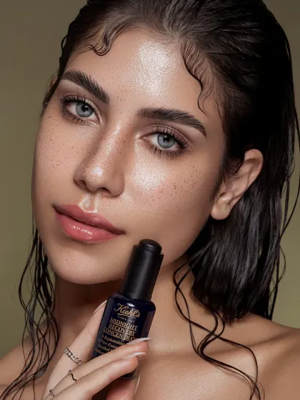 This close-up shot highlights the product while showcasing the model's radiant, freckled skin. It’s a celebration of natural beauty and effective skincare. The soft lighting and gentle pose create a feeling of trust and authenticity, connecting the viewer to the brand's promise.