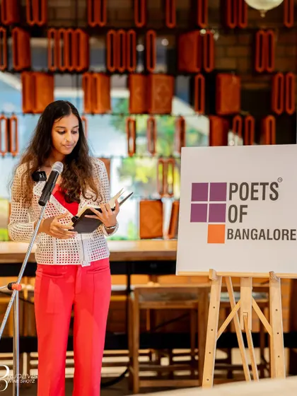 A young poet reads from her book, offering a fresh perspective on the "Wheel of Life".