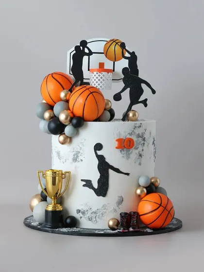 A slam dunk of a cake for a basketball fan. This design features fondant basketballs, player silhouettes, and a trophy, all on a modern, textured cake.