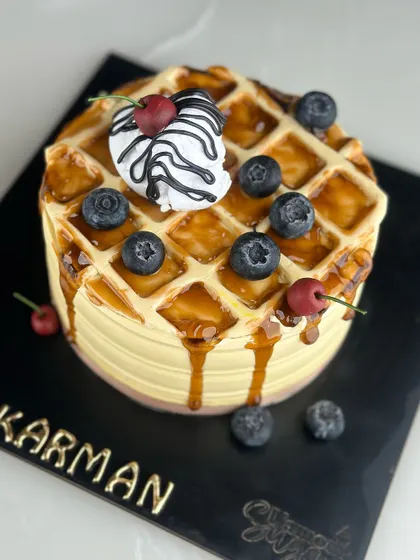 Sweeten your day with our waffle-themed cake. Combining the best of breakfast and dessert, it’s a stack of joy with every slice, drizzled with syrup and topped with berries.