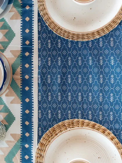 A top-down view of a table set with our blue-themed dining linen. The intricate patterns of the tablecloth and runner add a layer of artistry to the meal.