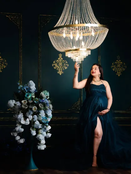 This is the kind of dramatic, elegant portrait we can create in the studio. I love using elements like this grand chandelier and a flowing gown to create a sense of magic and grandeur for the mom-to-be.