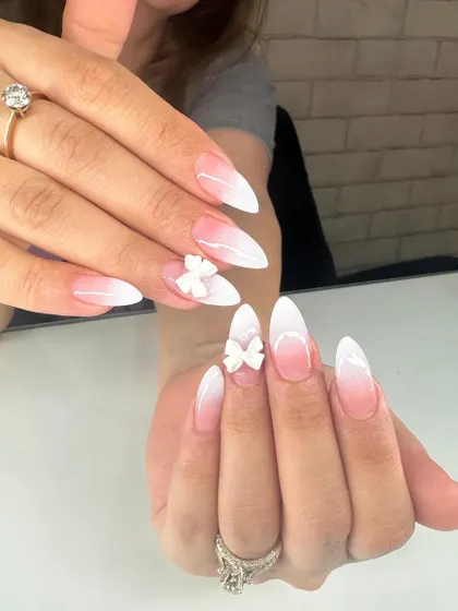 A beautiful baby boomer ombré in a sharp stiletto shape, made even more special with delicate, hand-sculpted 3D acrylic bows. This is a popular choice for bridal nails and special events.