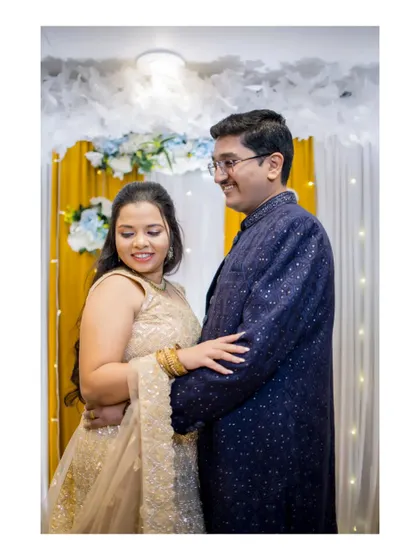 A candid moment of the couple interacting on their Sangeet stage, their smiles telling a story of love and happiness.