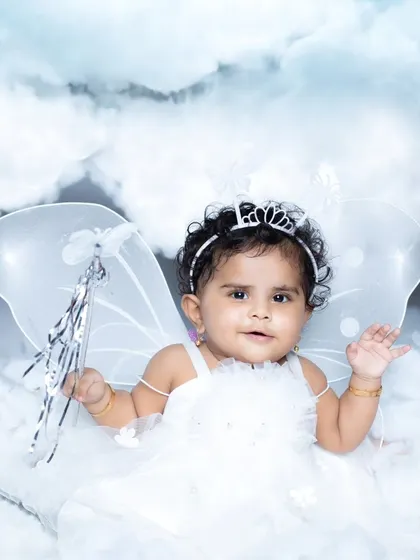 This little angel is holding a magic wand, ready to spread some joy.