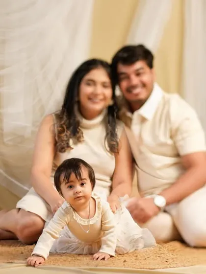 A soft and dreamy family portrait with our neutral-toned boho setup. The coordinated cream outfits and flowing fabrics create a serene and timeless image.