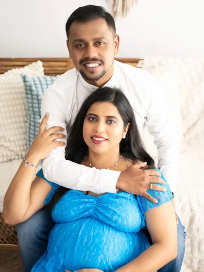 A happy and bright couple's portrait. Their smiles show the pure joy of expecting a new addition to their family.