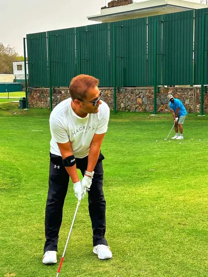 A golfer lines up his chip shot, demonstrating the focus required for a good short game.