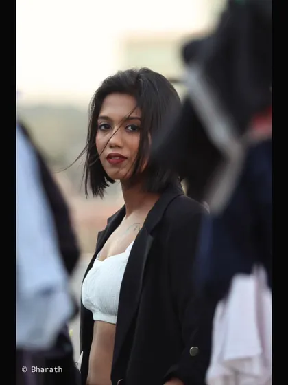 This shot captures a fleeting glance, framed by blurred objects that create a sense of intimacy and intrigue.