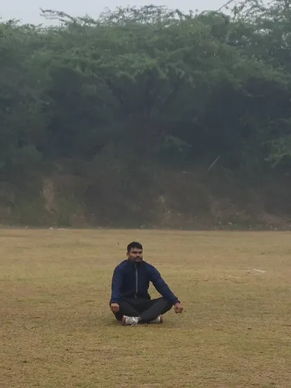 A senior cricketer, Vinod Yadav, finds a moment of calm and focus on our grounds. Mental preparation is as crucial as physical skill, a core part of our training philosophy.