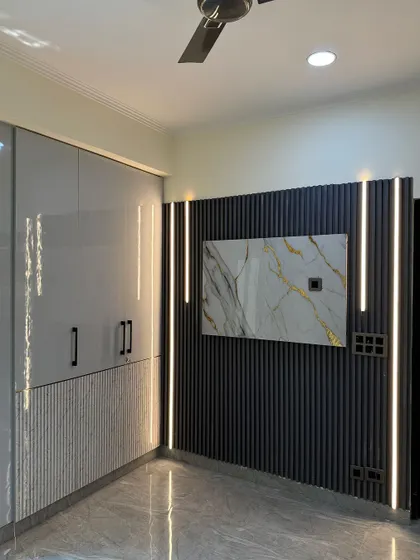 A stylish wardrobe with integrated lighting strips that frame the unit. The design combines high-gloss grey with a textured lower panel.