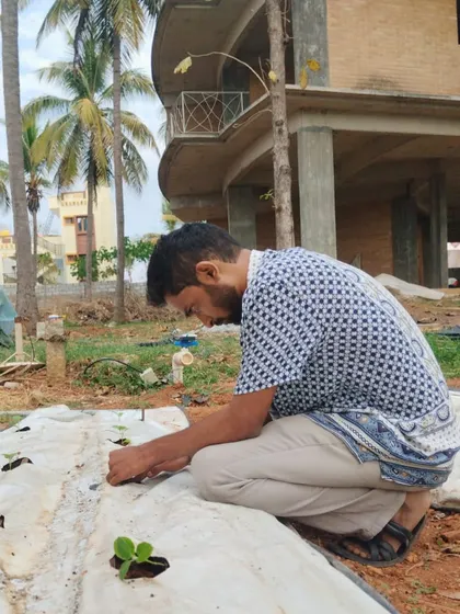 Hands on learning in action. This trainee is carefully planting seedlings, a core activity in our comprehensive hydroponics training that connects theory with practice.
