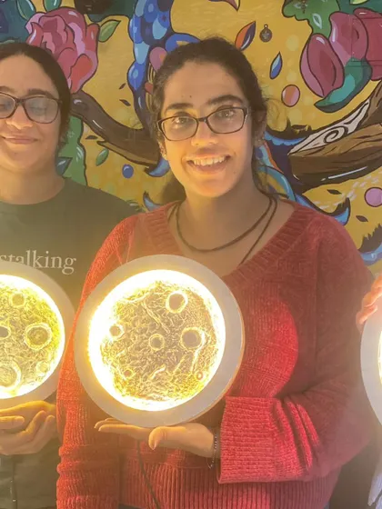 Another happy creator from our moon lamp workshop, showing off her glowing masterpiece.