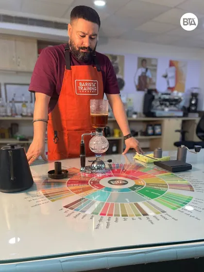 Our head trainer observing the syphon brewing process. We encourage students to explore various manual brewing devices.