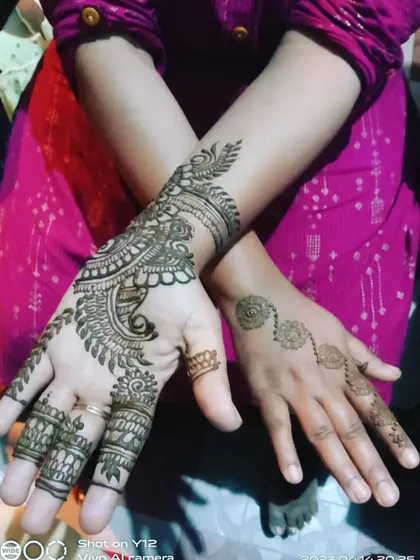 A fun pose showing one hand with a full Arabic design and the other with a simple spiral. This shows how you can mix and match styles for a unique look.