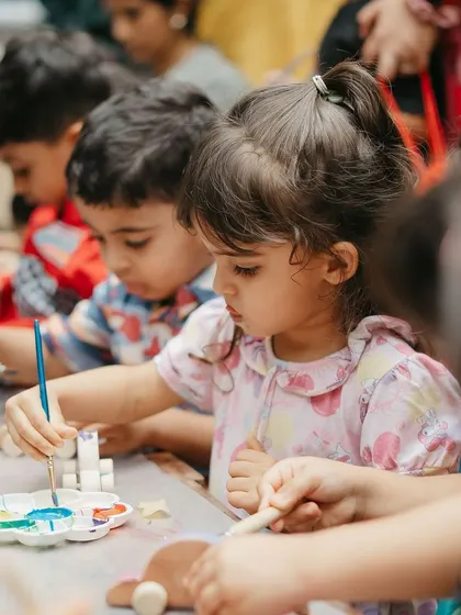 A young artist completely focused on her masterpiece. Our painting stations are designed to be accessible and fun for even the youngest party guests.
