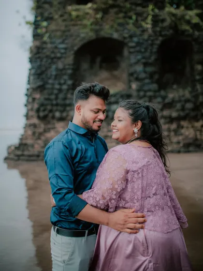 A happy, close-up portrait of a couple during their beach pre-wedding session.