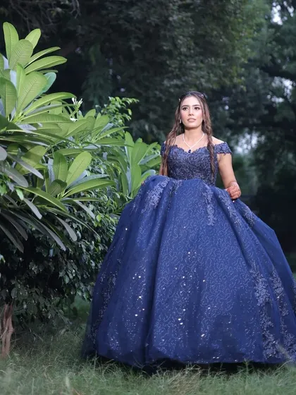 The grand blue gown paired with soft, elegant makeup creates a truly memorable engagement look.