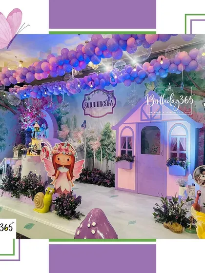Another perspective of the enchanting purple fairy-themed party, highlighting the custom-built fairy house and the immersive forest backdrop.