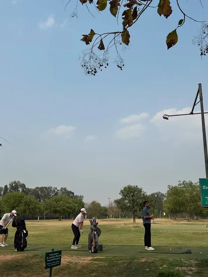 A group of golfers, including a coach, work together on the range. It's therapy with a view.