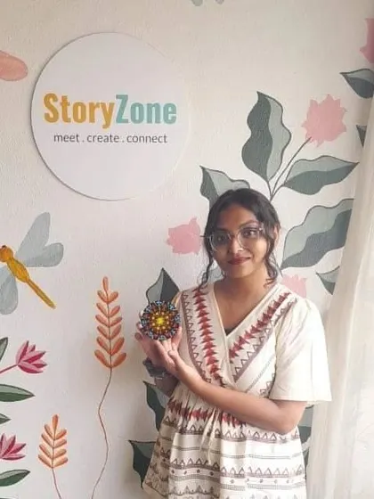 A participant with her beautiful, intricate dot mandala, created in our welcoming studio space.
