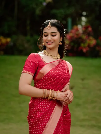 A lovely portrait of Shreeja. The soft, romantic hairstyle complements her elegant red saree.