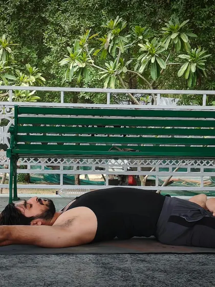 This is Supta Padmasana, the Lying Down Lotus Pose. It expands the chest to increase lung capacity and improves flexibility in the pelvic joints, making it a great restorative asana.