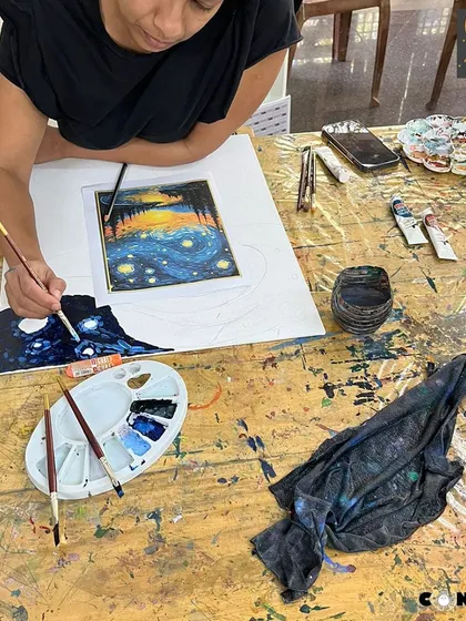 A student works on her own version of 'Starry Night', learning about Van Gogh's signature brushstrokes and color palette.